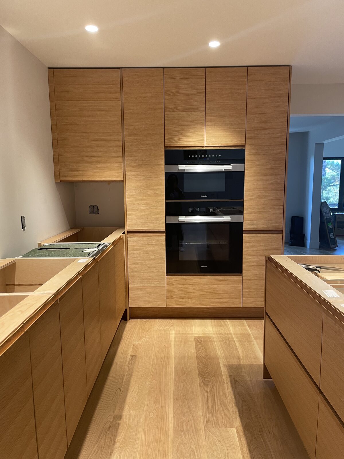 White oak pantry cabinet with pocket doors